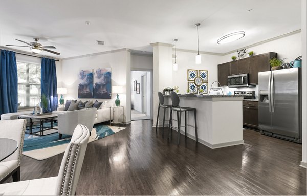 Contemporary kitchen with granite countertops and stainless steel appliances at 95Twenty Apartments