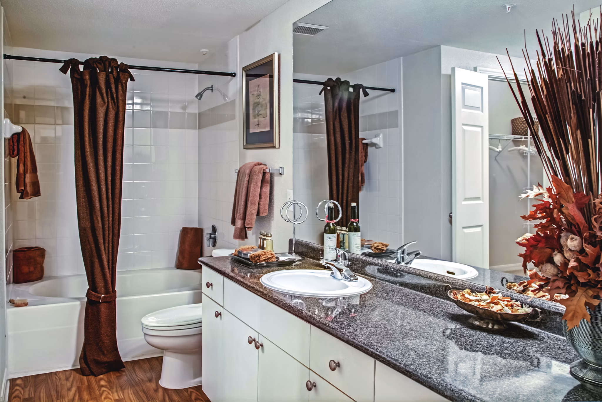 Bathroom with modern fixtures and marble countertops in Plaza at Westchase Apartments Luxury apartment bathroom design