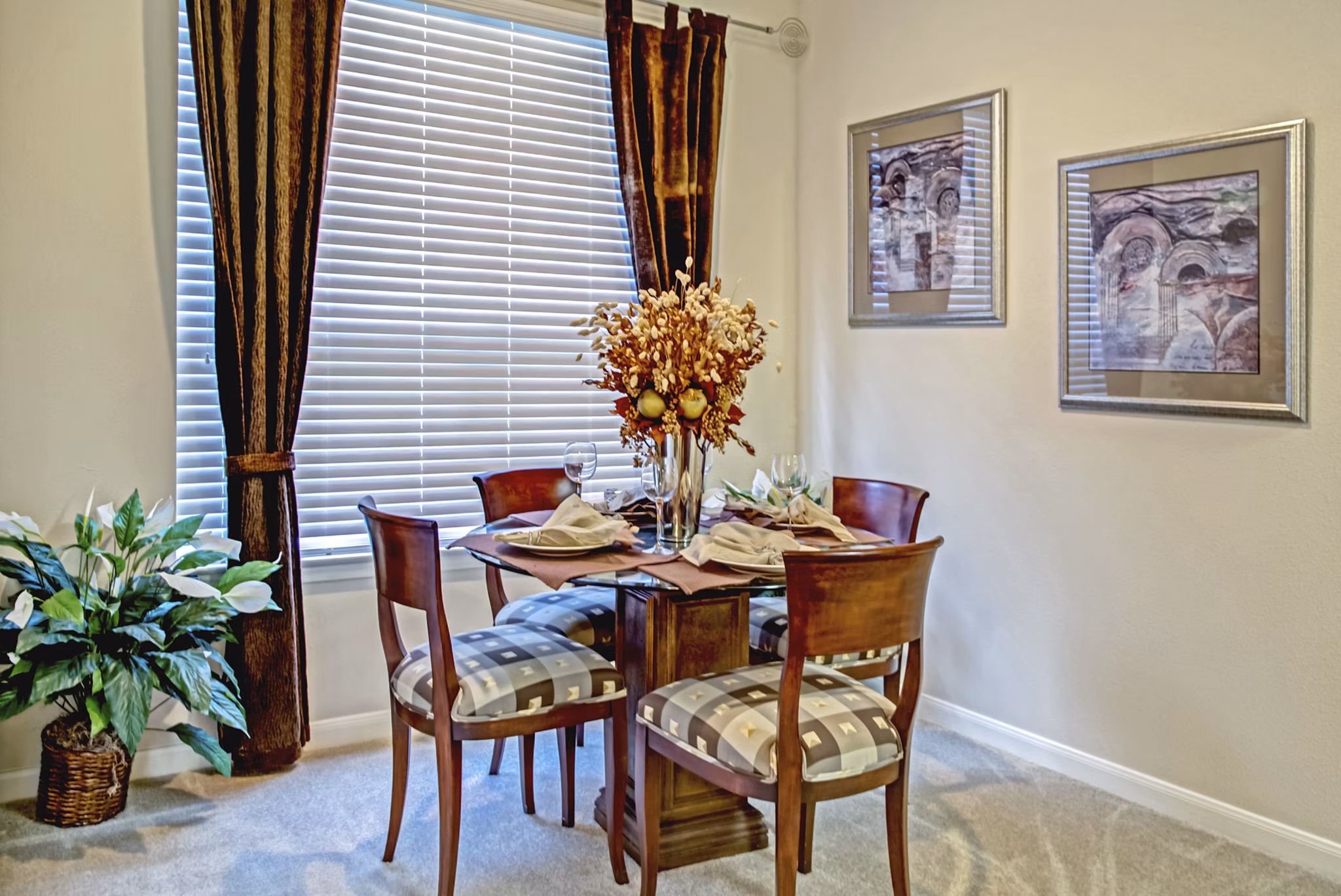 Dining room featuring elegant furnishings and pendant lighting at Plaza at Westchase Apartments, a representation of comfort and style in luxury living