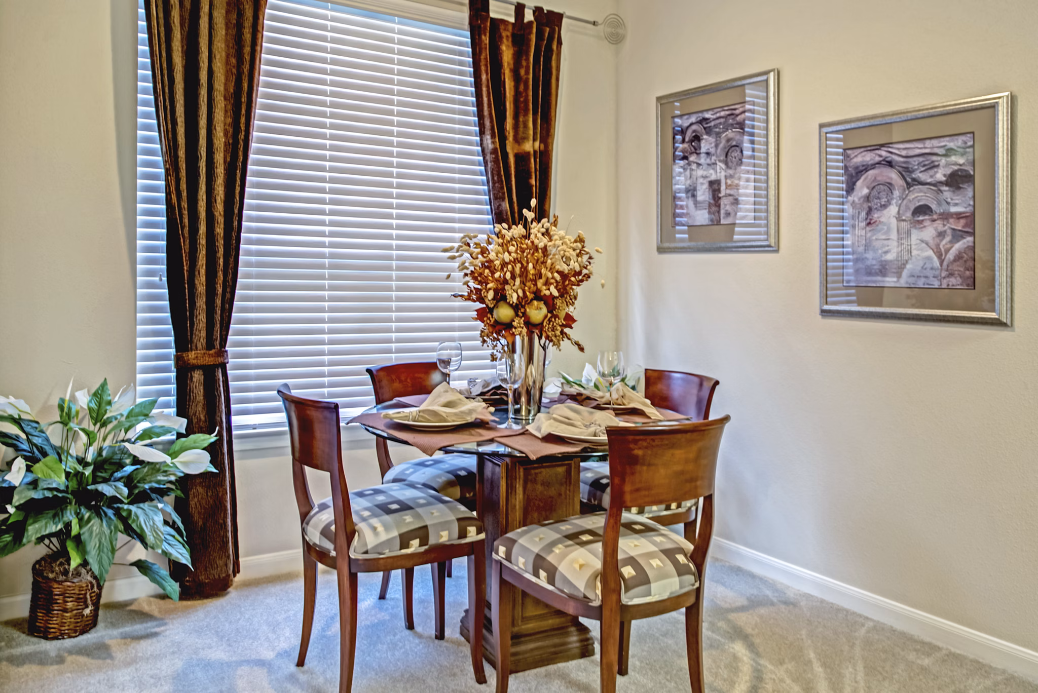 Dining room featuring elegant furnishings and pendant lighting at Plaza at Westchase Apartments, a representation of comfort and style in luxury living