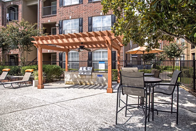Patio with cozy seating area at Plaza at Westchase Apartments, offering a relaxing outdoor space for residents to enjoy