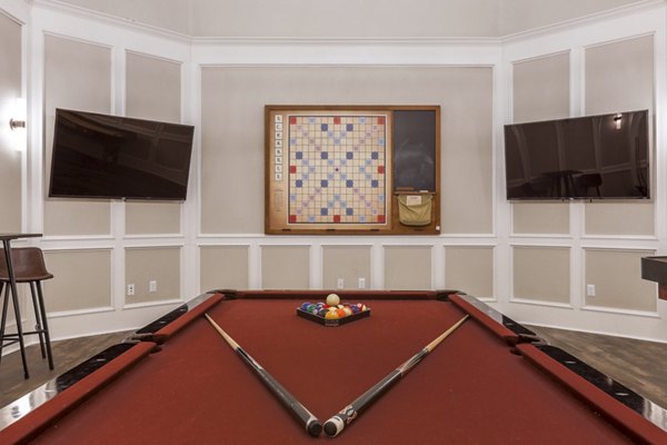 Game room with pool table and lounge seating at Avana Thornton Station Apartments