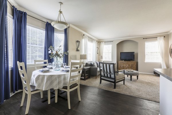 Dining area with modern furnishings at Avana Thornton Station Apartments, featuring stylish decor and ample natural light