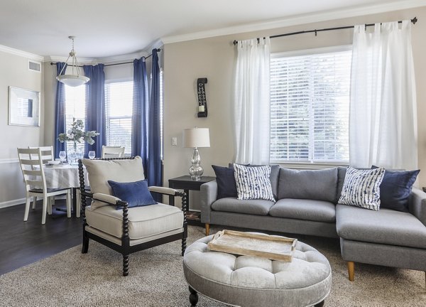 Modern living room with stylish furnishings and ample natural light at Avana Thornton Station Apartments