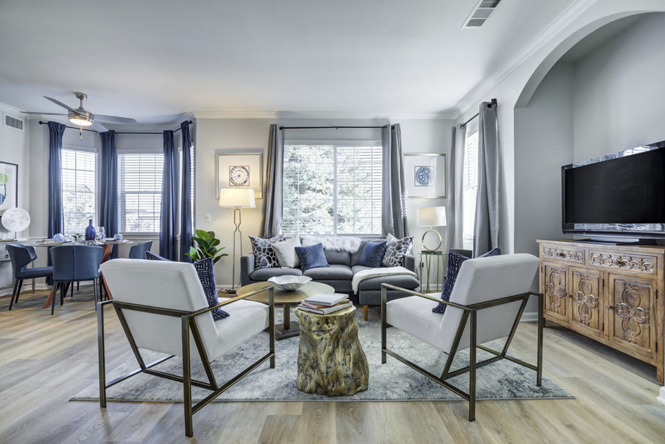 Modern living room with stylish furnishings and ample natural light at Avana Thornton Station Apartments