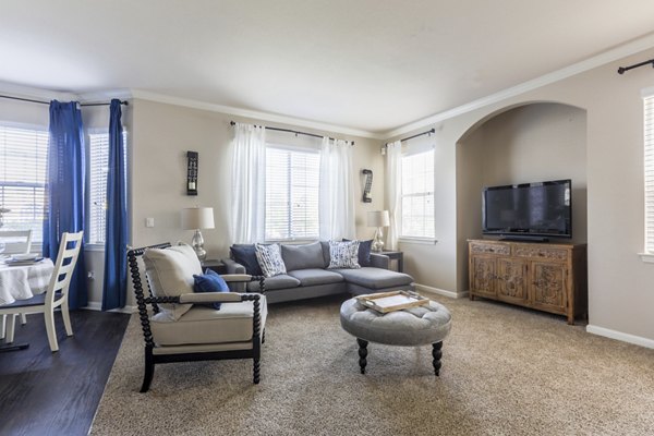 Spacious living room with contemporary furnishings in Avana Thornton Station Apartments