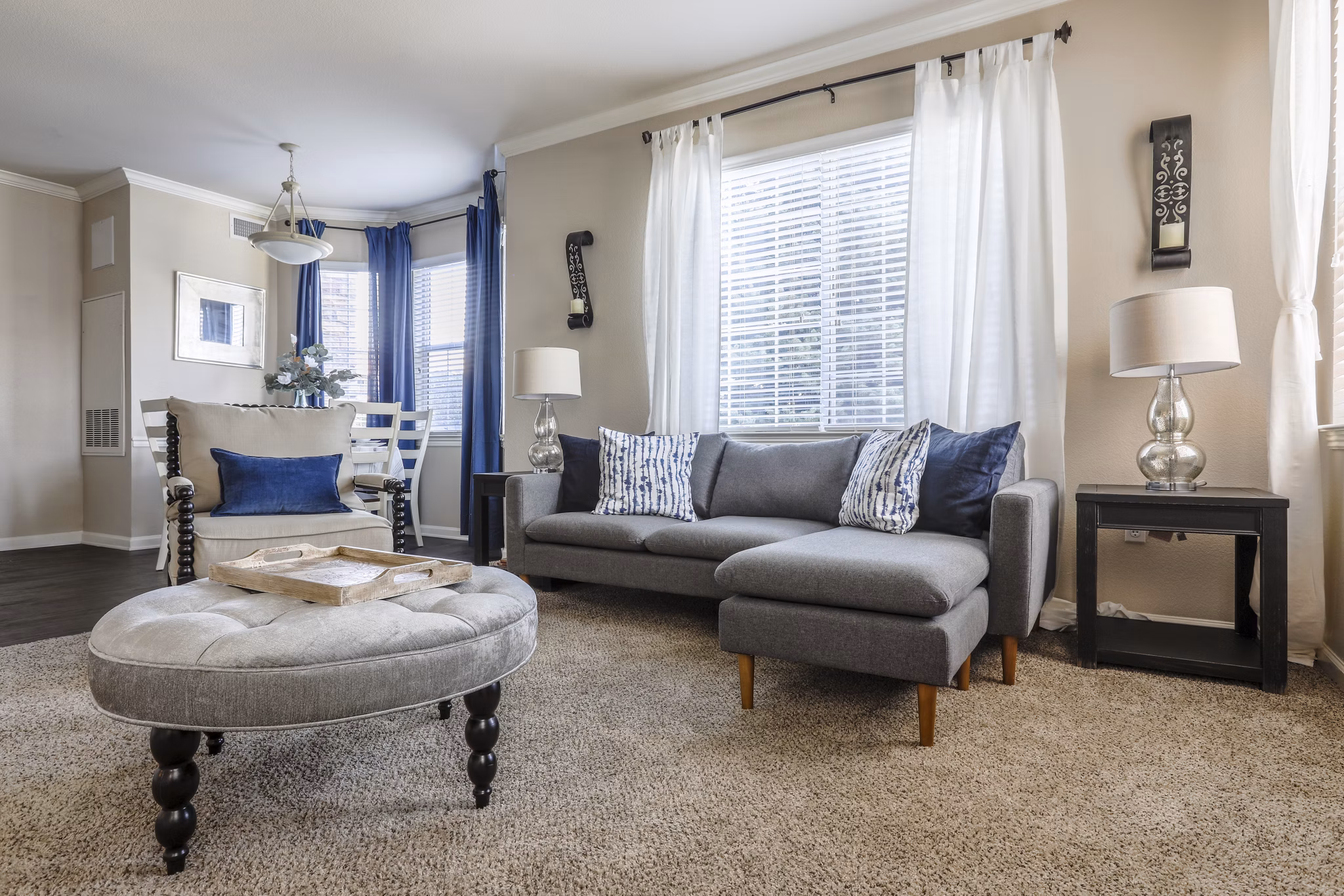 Modern living room with plush seating and large windows at Avana Thornton Station Apartments