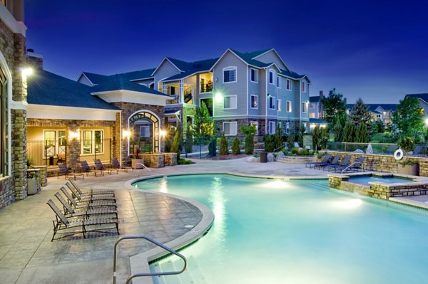 Outdoor pool with lounge seating at Avana Thornton Station Apartments