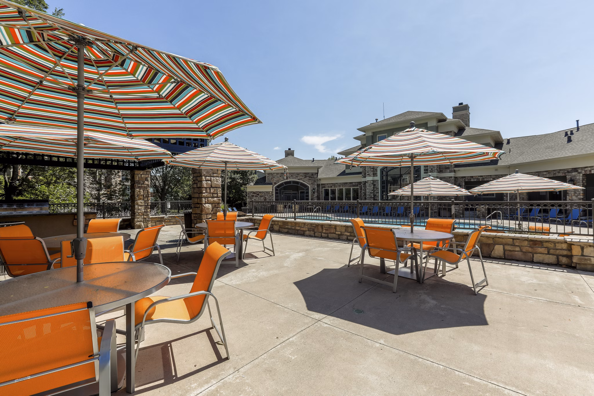 Outdoor patio with seating area at Avana Thornton Station Apartments featuring lush landscaping