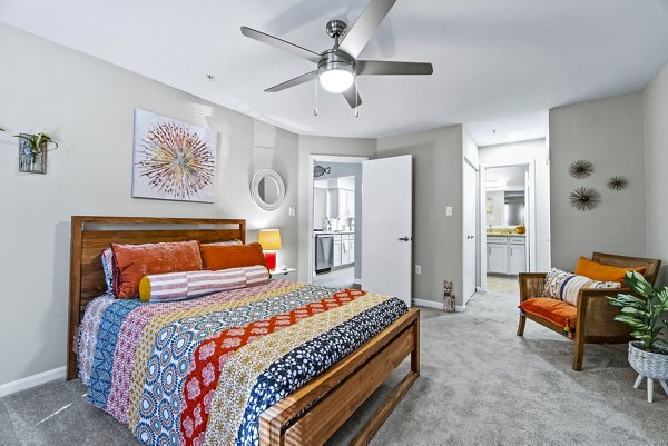 Ellipse at Fairfax Corner: Modern bedroom featuring cozy decor and ample natural light in luxury apartments