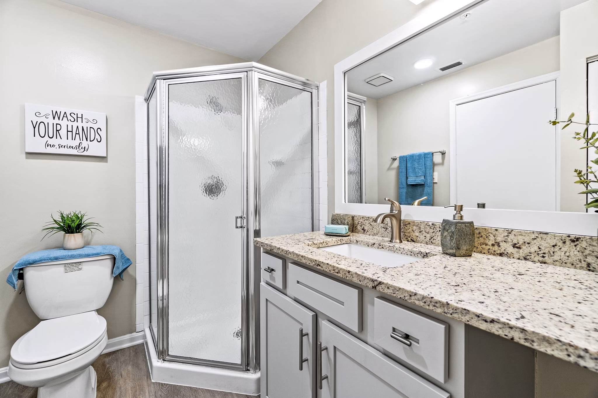 Modern bathroom featuring elegant fixtures and large vanity at Ellipse at Fairfax Corner Apartments