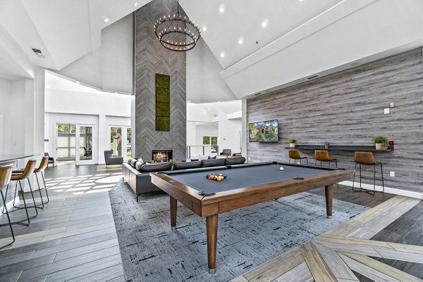 Clubhouse game room featuring pool table and lounge area at Ellipse at Fairfax Corner Apartments, luxury living in Fairfax