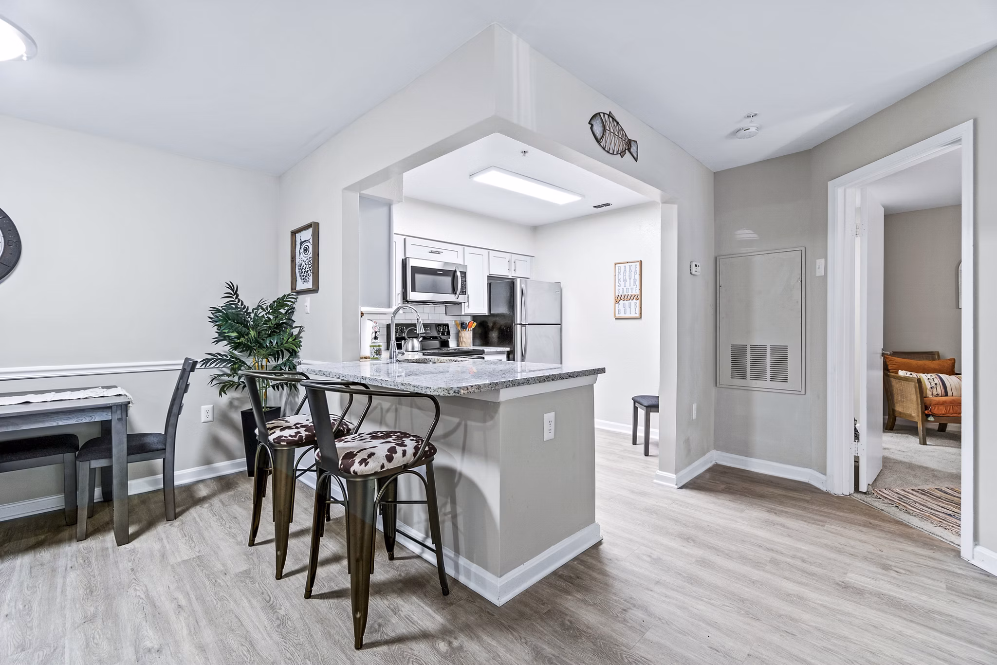 Dining room with elegant decor and modern furniture in Ellipse at Fairfax Corner Apartments, luxury living spaces