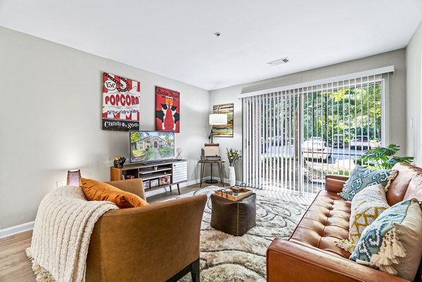 Spacious living room with modern decor in Ellipse at Fairfax Corner Apartments