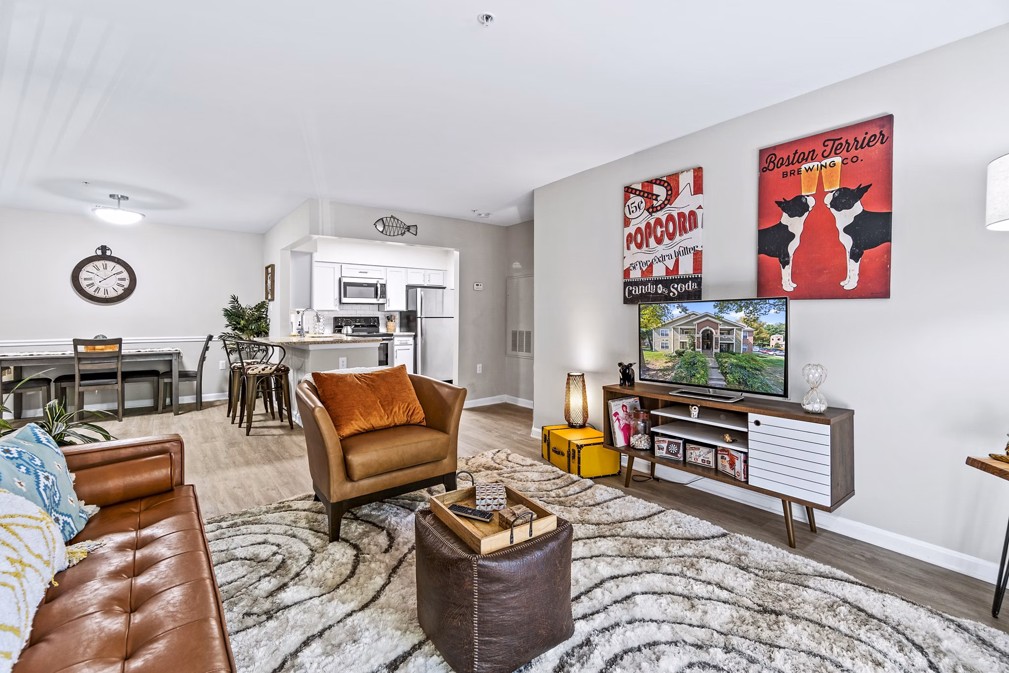 Living room with modern furnishings and large windows at Ellipse at Fairfax Corner Apartments