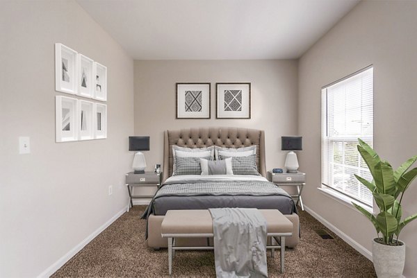 Bedroom with cozy queen bed and modern decor in Townes at Herndon Apartments