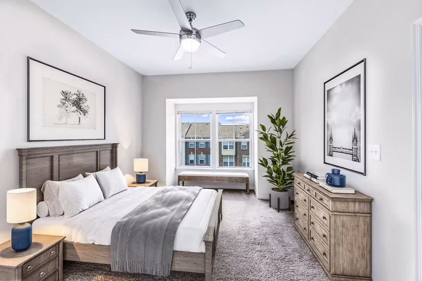 Bedroom with cozy ambiance and modern decor at Townes at Herndon Apartments, offering luxury living spaces for ultimate comfort and style