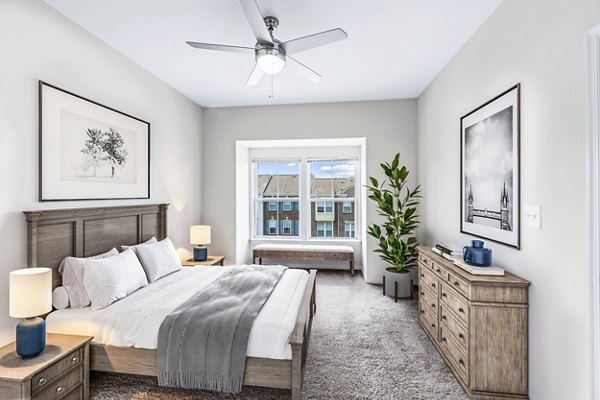 Bedroom with cozy ambiance and modern decor at Townes at Herndon Apartments, offering luxury living spaces for ultimate comfort and style