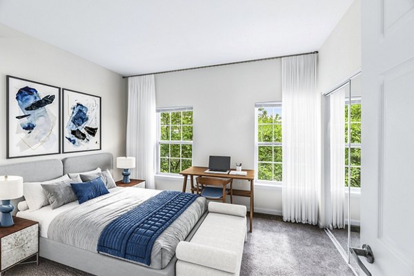 Cozy bedroom with modern furnishings at Townes at Herndon Apartments