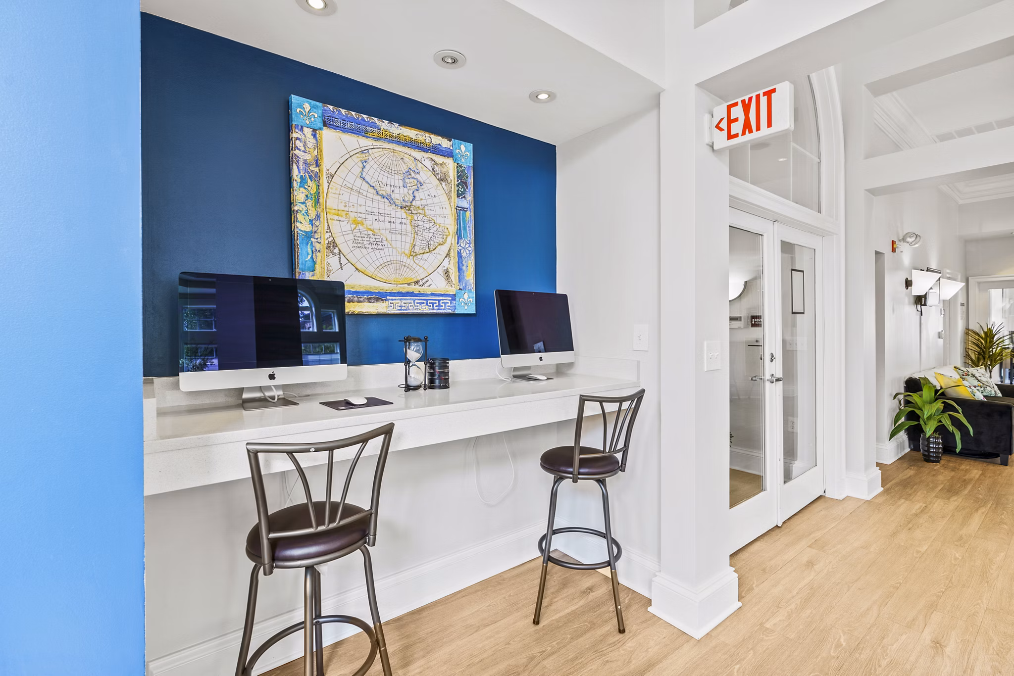 Clubhouse business center with modern workstations at Townes at Herndon Apartments, ideal for residents needing flexible workspace solutions