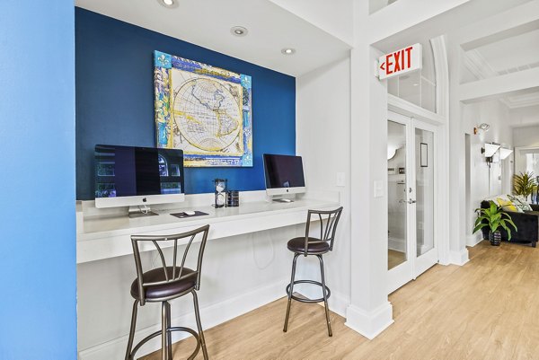Clubhouse business center with modern workstations at Townes at Herndon Apartments, ideal for residents needing flexible workspace solutions