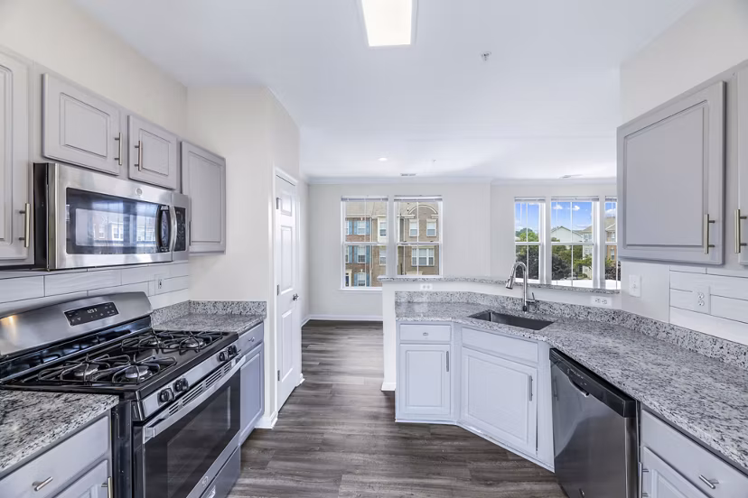 Modern kitchen with stainless steel appliances at Townes at Herndon Apartments