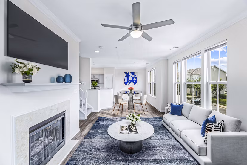Cozy living room with modern furnishings and natural light at Townes at Herndon Apartments
