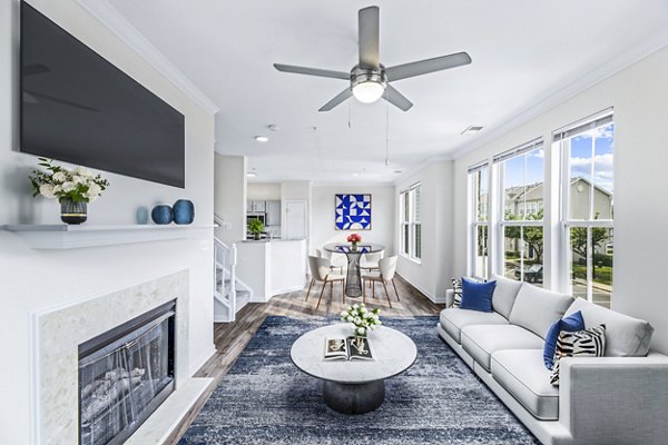Cozy living room with modern furnishings and natural light at Townes at Herndon Apartments