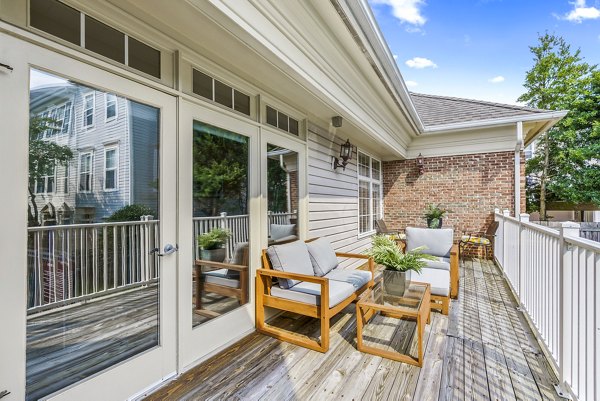 Clubhouse patio with modern seating at Townes at Herndon Apartments, ideal for social gatherings and relaxation in a luxury setting