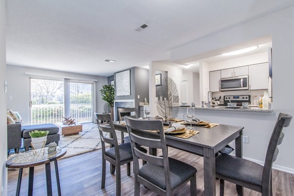 Dining room with elegant seating and modern lighting at Windsor at Fairlakes Apartments