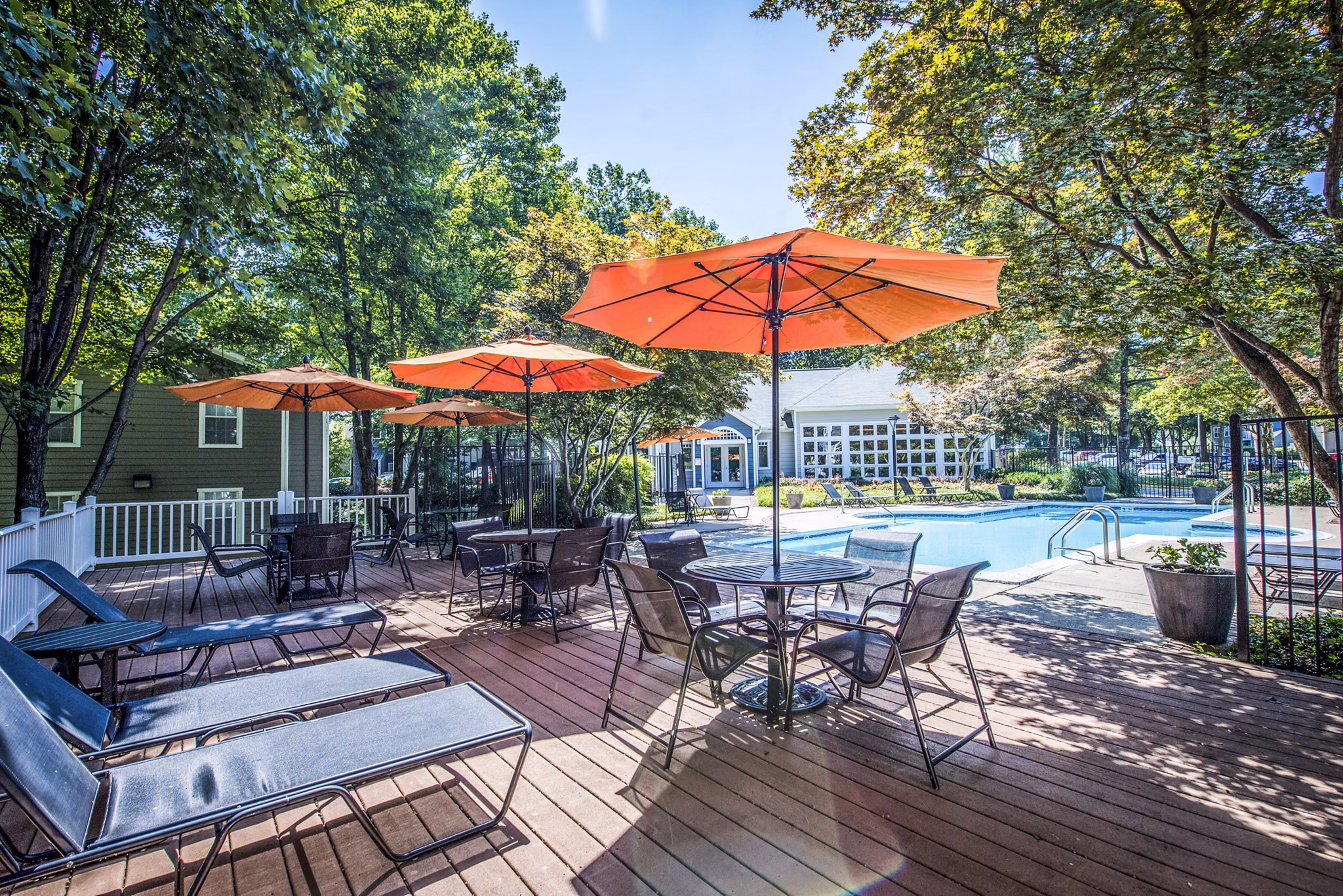 Relaxing pool patio with lounge chairs at Windsor at Fairlakes Apartments