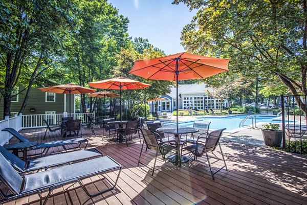 Relaxing pool patio with lounge chairs at Windsor at Fairlakes Apartments