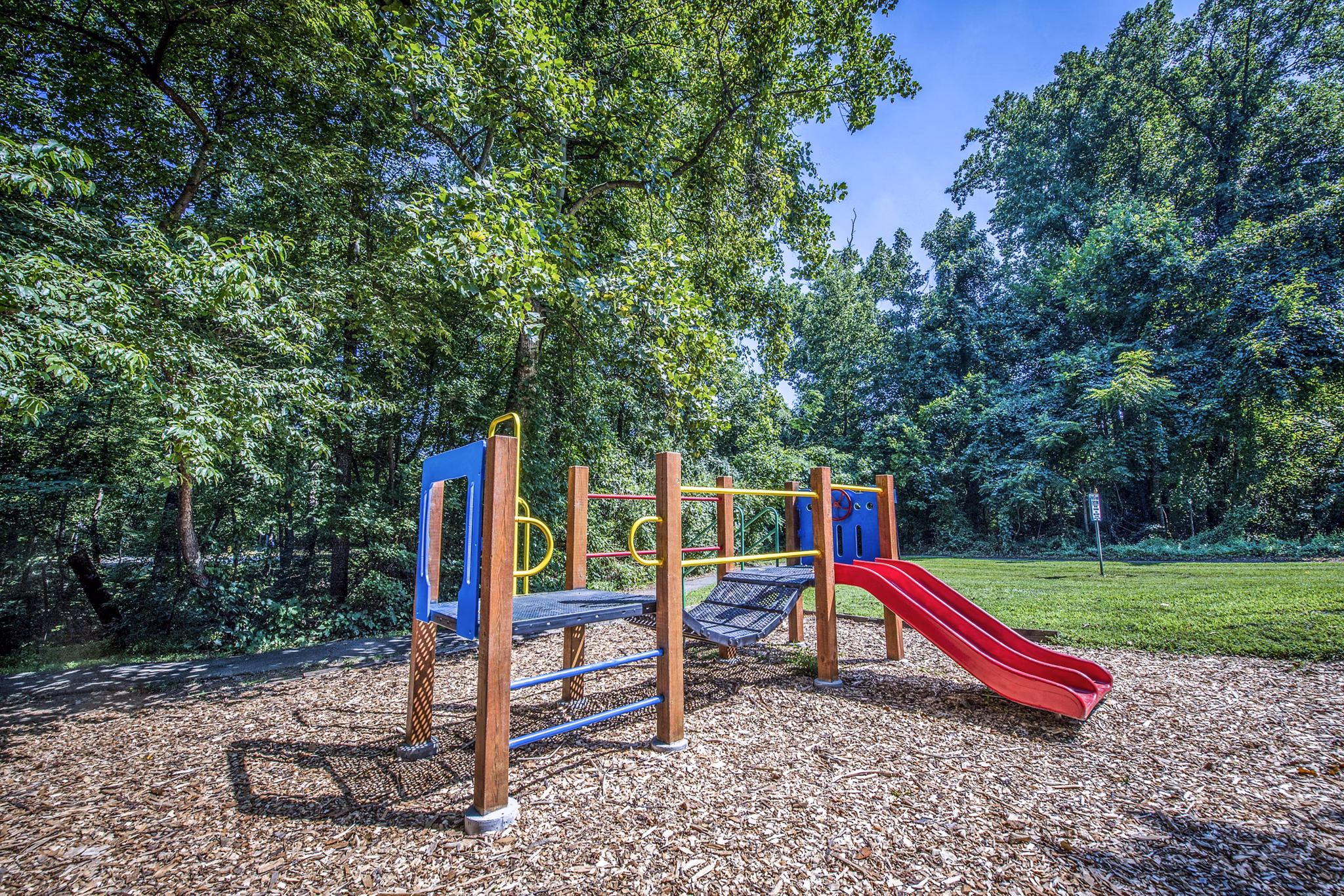 Children's playground with swings and slides at Windsor at Fairlakes Apartments