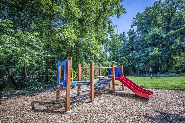 Children's playground with swings and slides at Windsor at Fairlakes Apartments