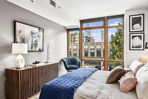 Spacious bedroom with modern furnishings at The Goodwin Apartments