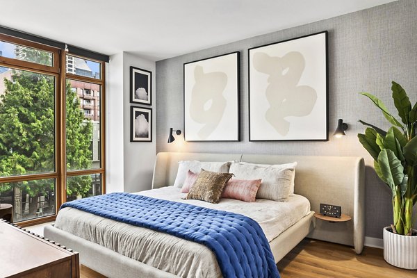 Cozy bedroom with modern decor at The Goodwin Apartments