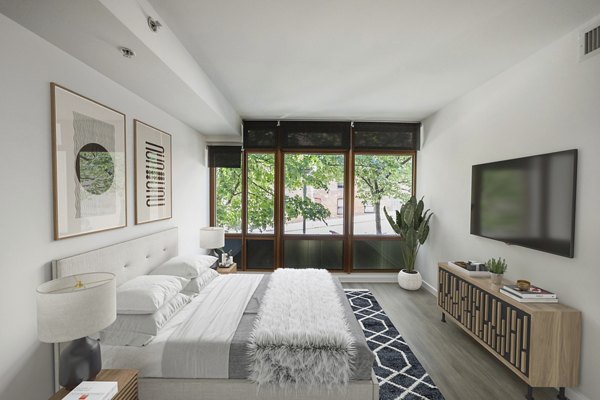 Bedroom featuring elegant decor and natural light at The Goodwin Apartments