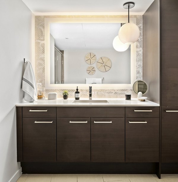 Bathroom featuring sleek fixtures and modern design at The Goodwin Apartments