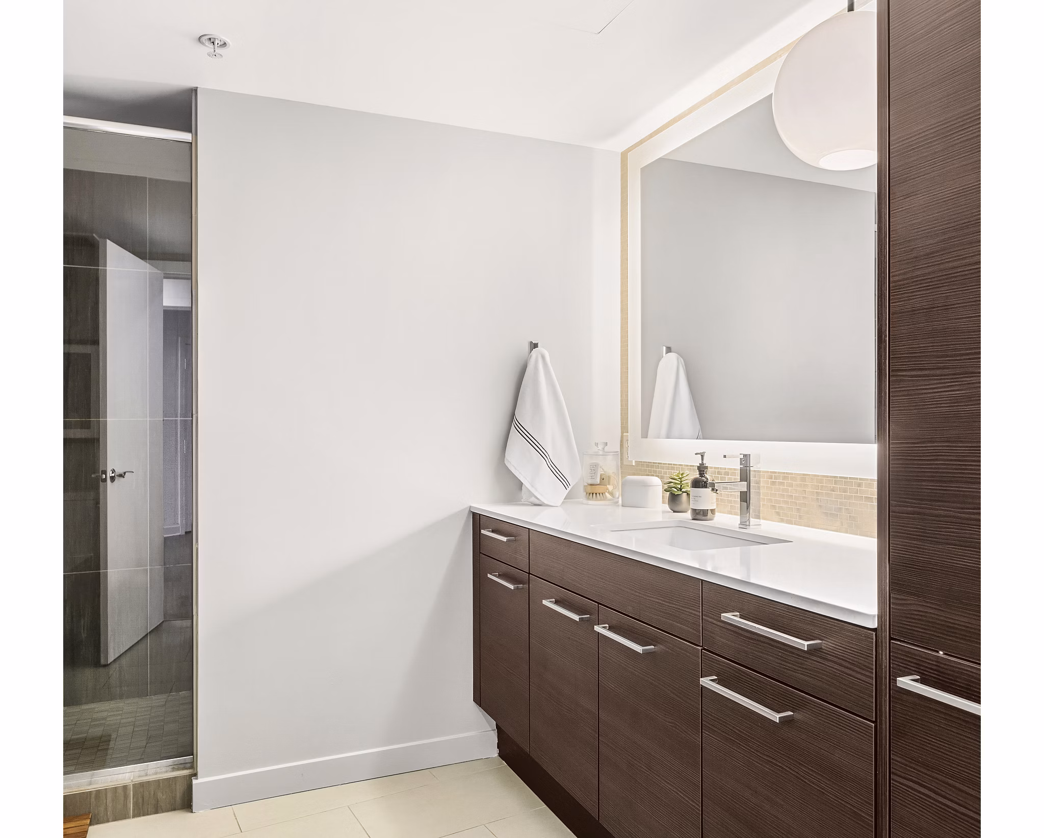 Bathroom featuring modern fixtures and elegant tiling at The Goodwin Apartments