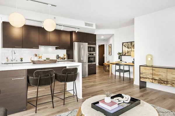 Modern kitchen with stainless steel appliances at The Goodwin Apartments