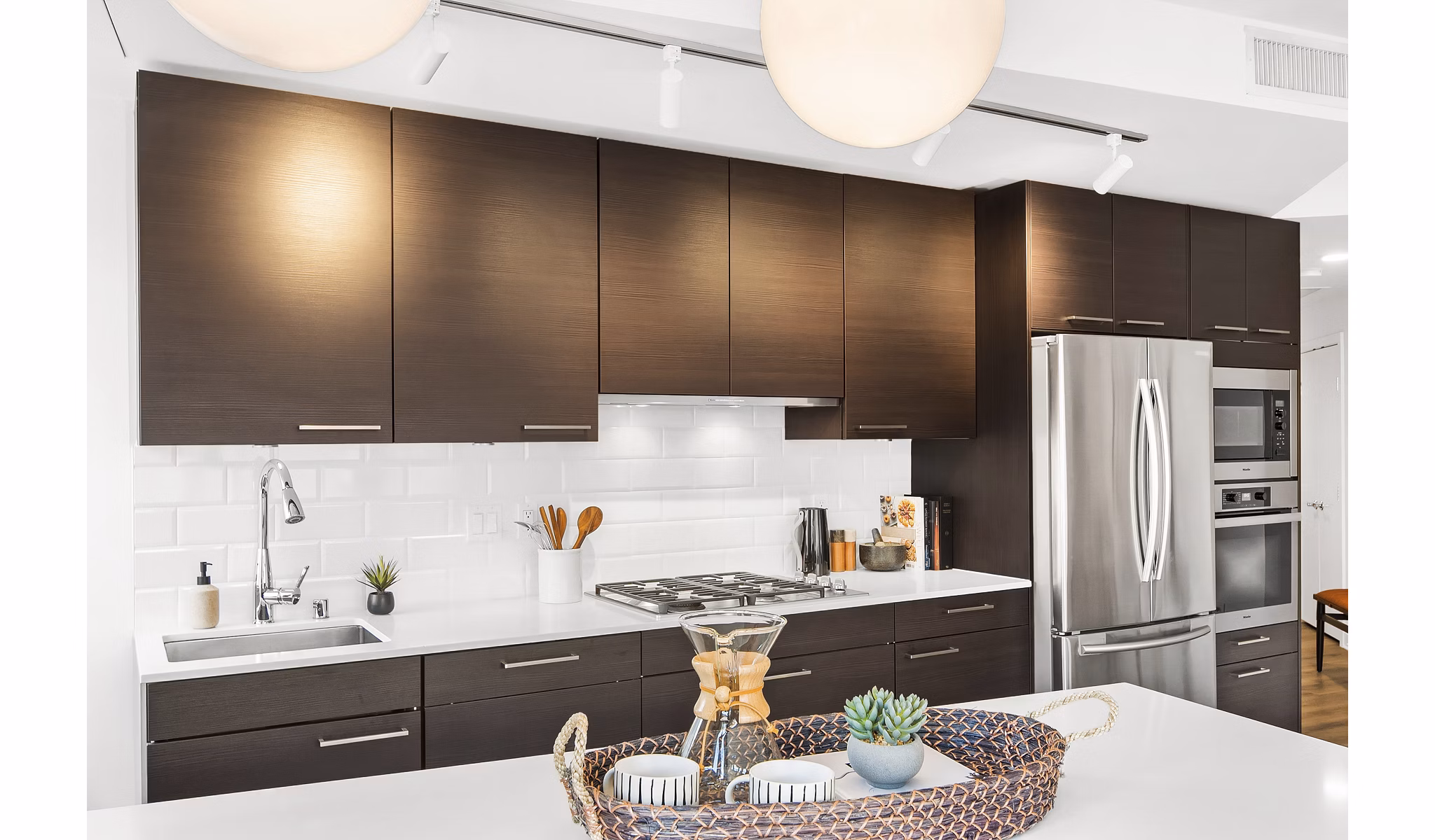 Modern kitchen with stainless steel appliances and sleek countertops at The Goodwin Apartments