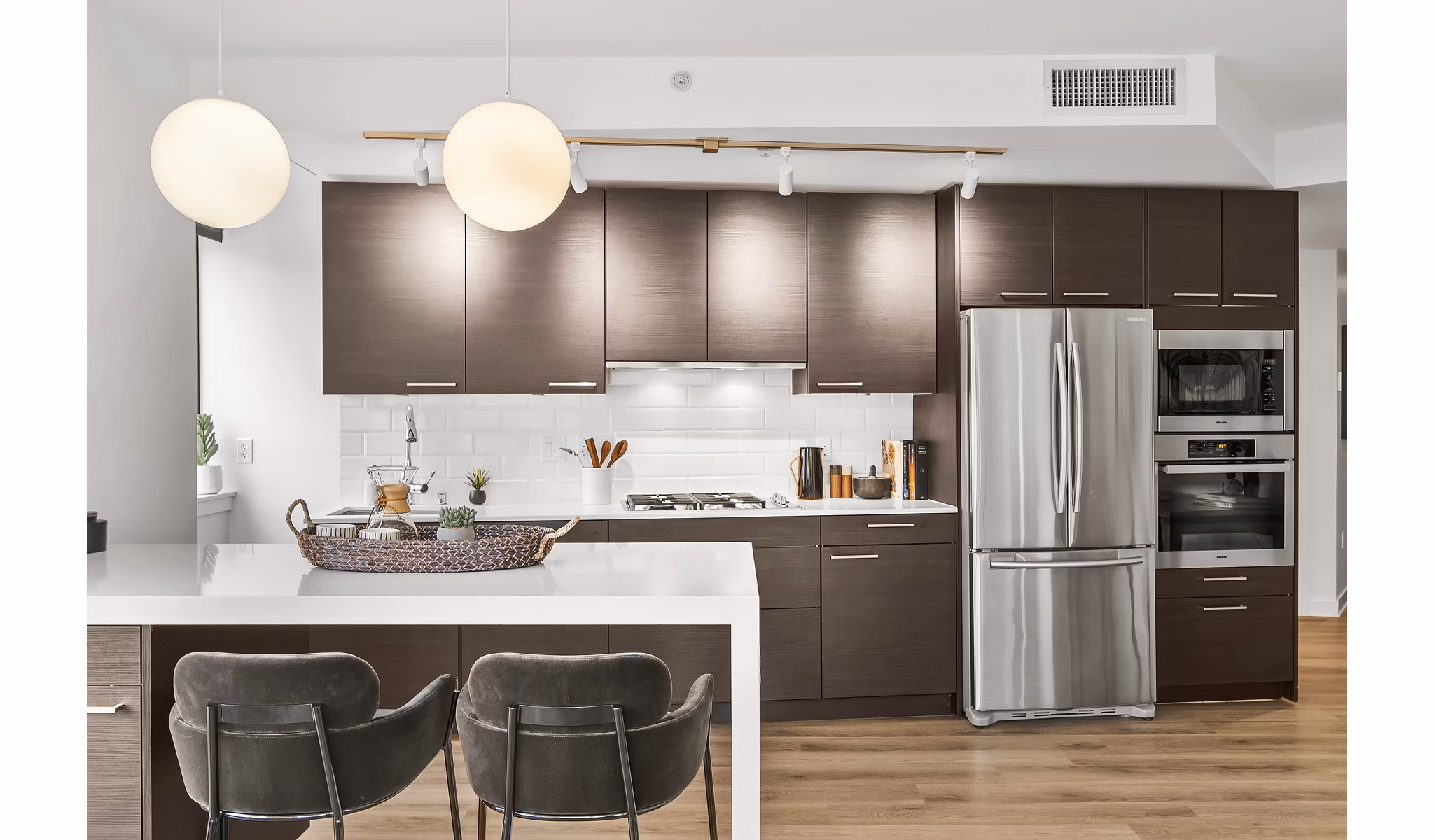 Kitchen featuring modern appliances and granite countertops in The Goodwin Apartments, a luxury residence designed by Greystar