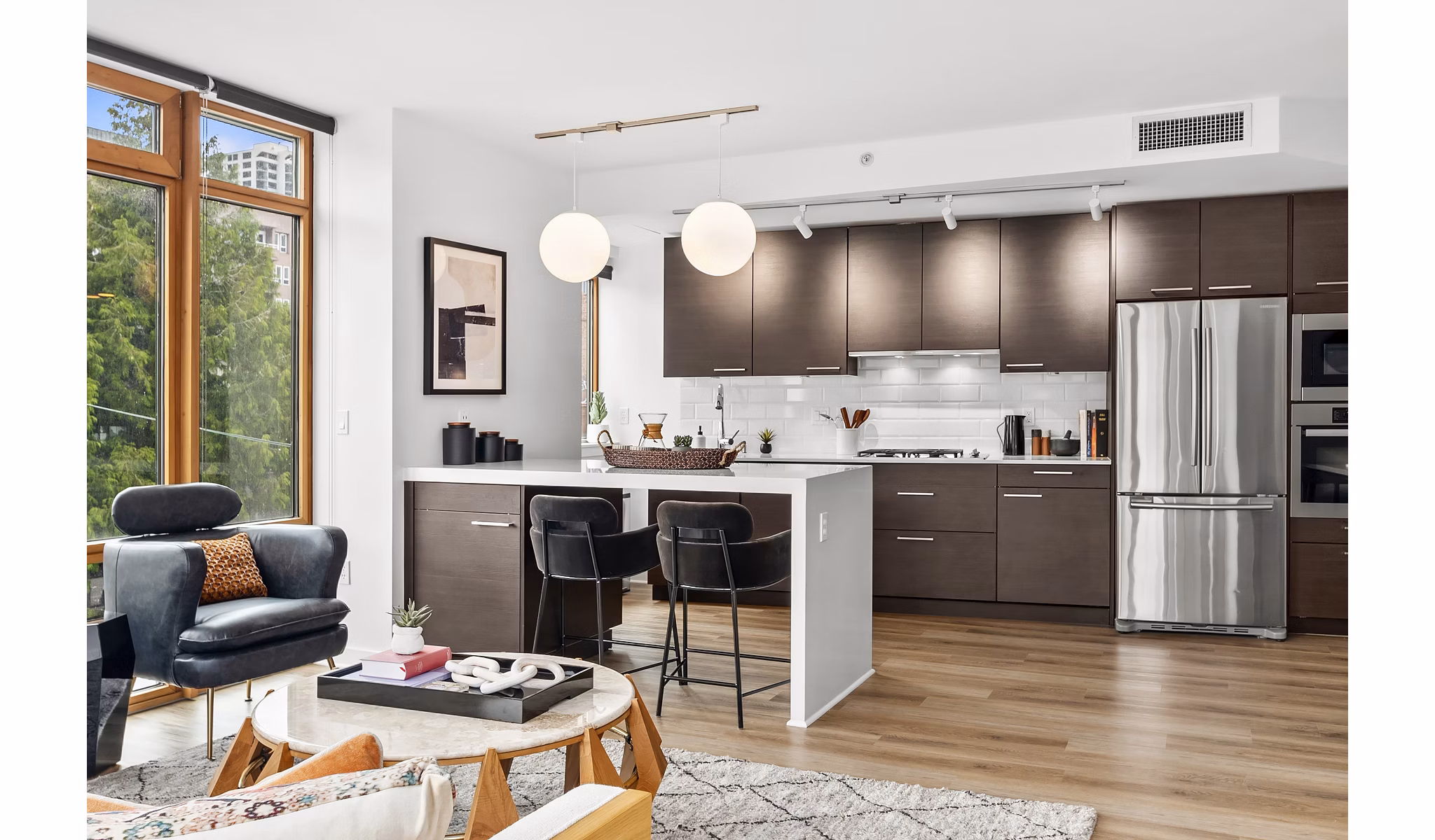 Modern kitchen with sleek countertops and stainless steel appliances at The Goodwin Apartments
