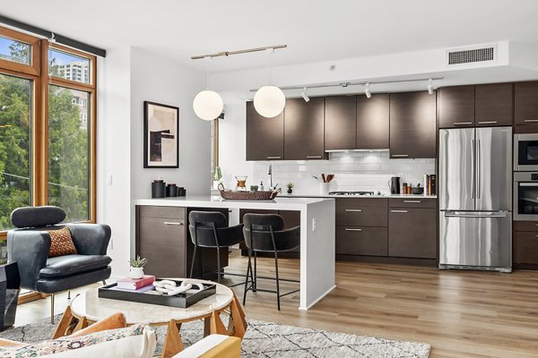 Modern kitchen with sleek countertops and stainless steel appliances at The Goodwin Apartments