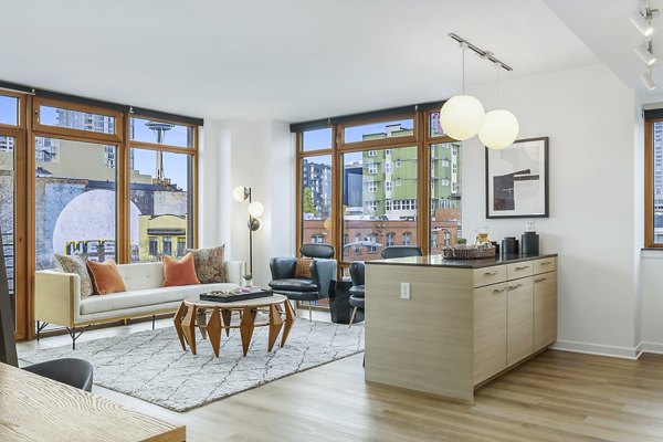 Spacious living room with modern decor at The Goodwin Apartments, featuring luxury finishes and ample natural light