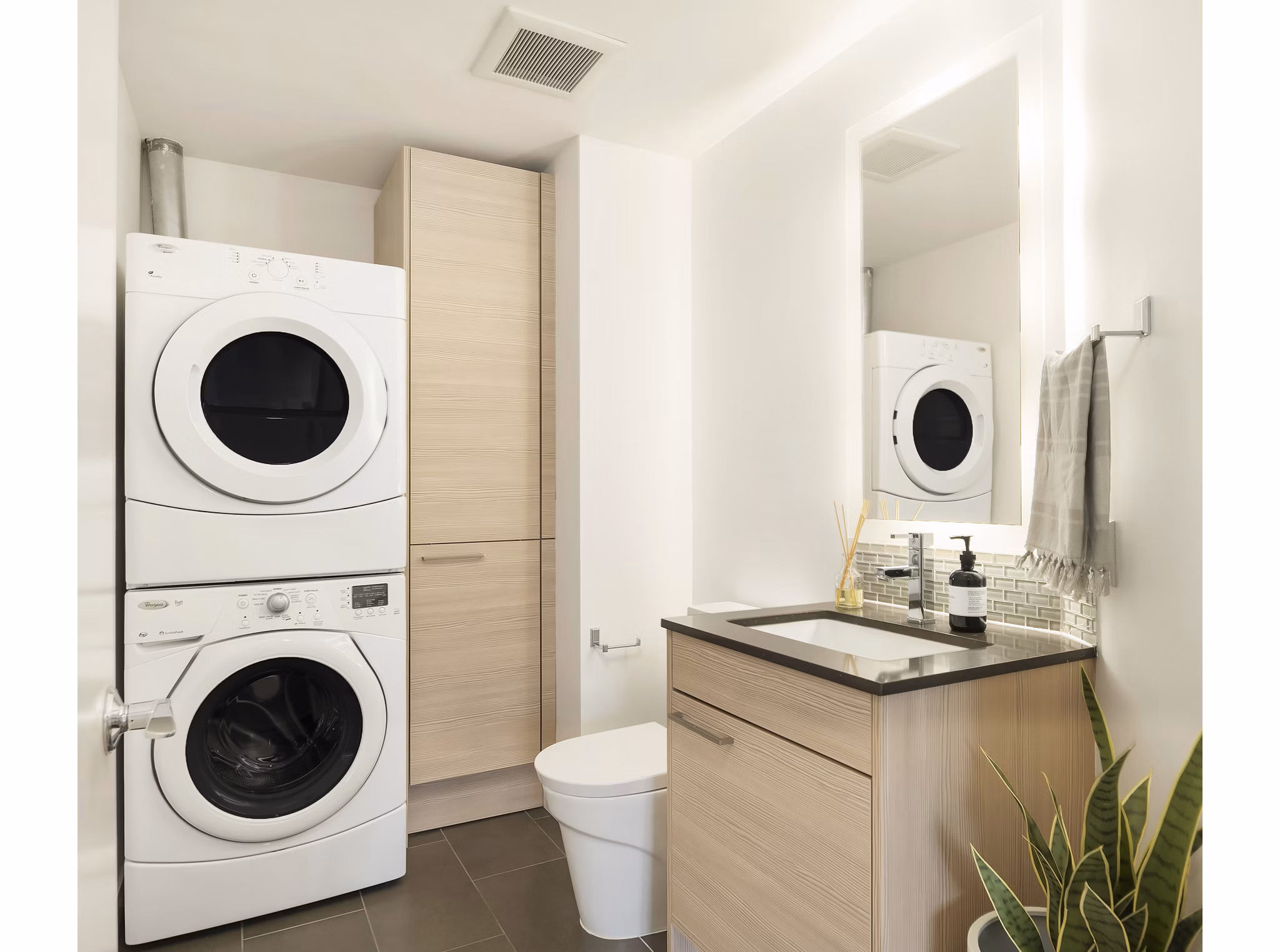Bath and laundry room with modern fixtures at The Goodwin Apartments