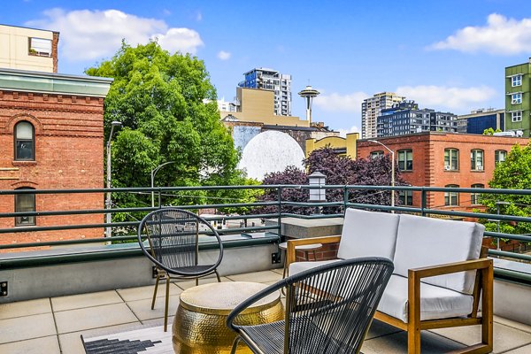 The Goodwin Apartments: Stylish patio with outdoor seating and greenery