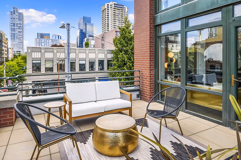 Modern outdoor patio at The Goodwin Apartments with lounge seating and greenery