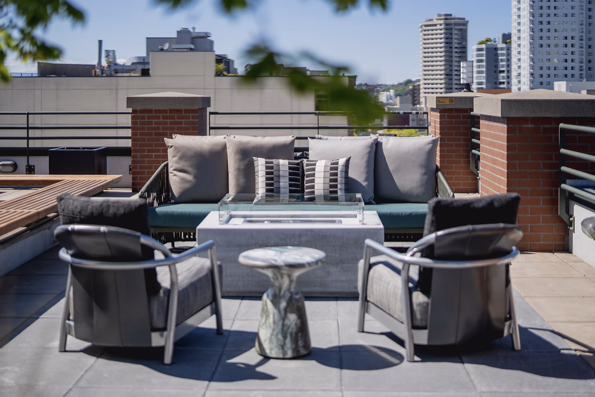 Cozy fire pit on a stylish patio at The Goodwin Apartments, perfect for outdoor gatherings and relaxation