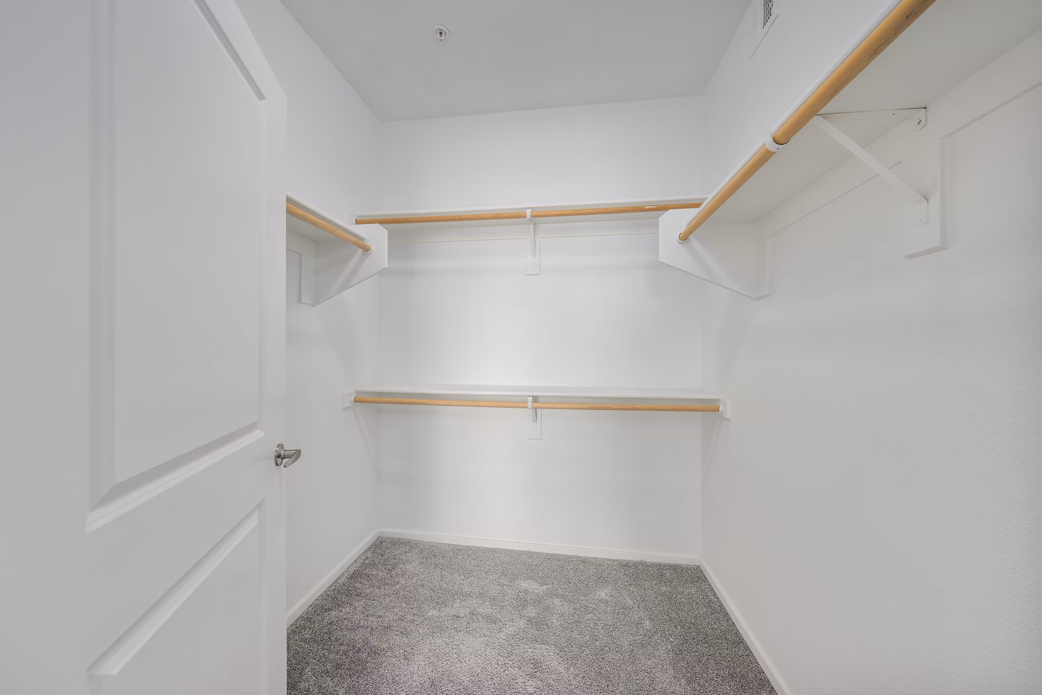 Spacious closet with built-in shelving in the master bedroom at Indigo Apartments
